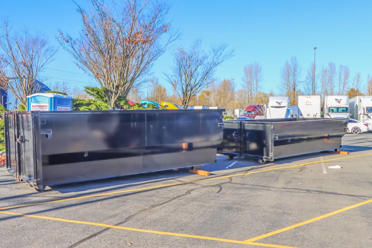 Professional dumpster rental service with roll-off container on residential driveway in Nyack